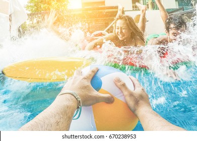 Group Of Friends Jumping Inside Swimming Pool In Summer Tropical Vacation - Young People Having Fun Splashing Into The Water At Beach Club Party - Youth Concept - Main Focus On Ball Hands