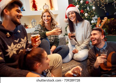 Group Of Friends Laughing On Christmas Party
