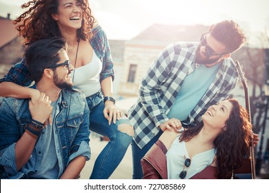 Group of friends laughing and walking at the city downtown.They embrace each other and smiling. - Powered by Shutterstock