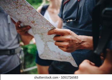 Group of friends looking at a map while hiking
