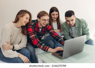 Group Of Friends Looking At Something On A Laptop Computer