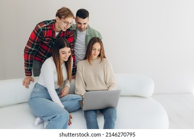 Group Of Friends Looking At Something On A Laptop Computer