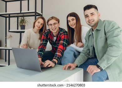 Group Of Friends Looking At Something On A Laptop Computer