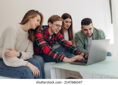 Group Of Friends Looking At Something On A Laptop Computer