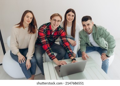 Group Of Friends Looking At Something On A Laptop Computer