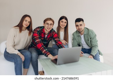 Group Of Friends Looking At Something On A Laptop Computer