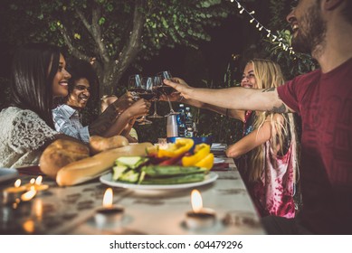 Group Of Friends Making Barbecue In The Backyard At Dinner Time