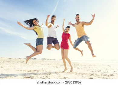 Group Of Friends Making A Jump Together At The Beach