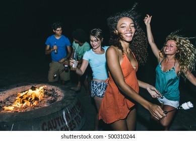 Group Of Friends Making Party On The Beach With Fire And Music