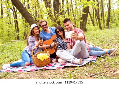 Group of friends making selfie and enjoying picnic day together