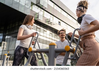 Group Of Friends Man And Women Male And Young Adult People Training At Outdoor Open Gym In Park In Front Of Modern Building Real People Sport And Recreation Exercise Healthy Lifestyle Concept