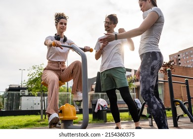 Group Of Friends Man And Women Male And Young Adult People Training At Outdoor Open Gym In Park In Front Of Modern Building Real People Sport And Recreation Exercise Healthy Lifestyle Concept