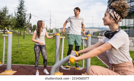 Group Of Friends Man And Women Male And Young Adult People Training At Outdoor Open Gym In Park In Front Of Modern Building Real People Sport And Recreation Exercise Healthy Lifestyle Concept