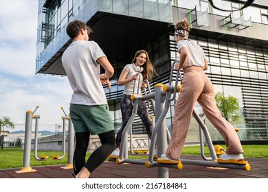 Group Of Friends Man And Women Male And Young Adult People Training At Outdoor Open Gym In Park In Front Of Modern Building Real People Sport And Recreation Exercise Healthy Lifestyle Concept