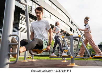 Group Of Friends Man And Women Male And Young Adult People Training At Outdoor Open Gym In Park In Front Of Modern Building Real People Sport And Recreation Exercise Healthy Lifestyle Concept