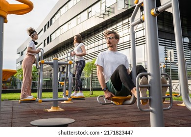 Group Of Friends Man And Women Male And Young Adult People Training At Outdoor Open Gym In Park In Front Of Modern Building Real People Sport And Recreation Exercise Healthy Lifestyle Concept