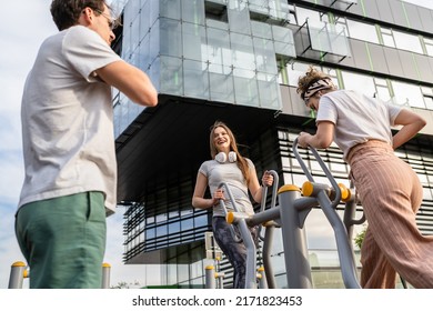 Group Of Friends Man And Women Male And Young Adult People Training At Outdoor Open Gym In Park In Front Of Modern Building Real People Sport And Recreation Exercise Healthy Lifestyle Concept