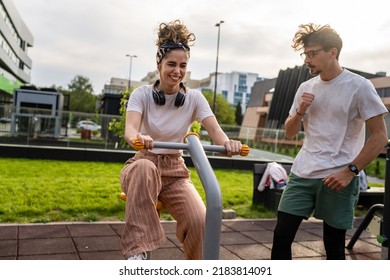 Group Of Friends Man And Women Male And Young Adult People Training At Outdoor Open Gym In Park In Front Of Modern Building Real People Sport And Recreation Exercise Healthy Lifestyle Concept