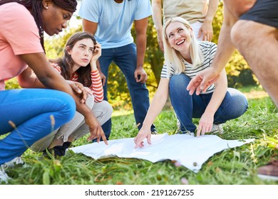 Group of friends with a map on the treasure hunt for cooperation and challenge - Shutterstock ID 2191267255