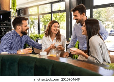 Group of friends met at the restaurant. They hang out, drink coffee and laugh. - Powered by Shutterstock