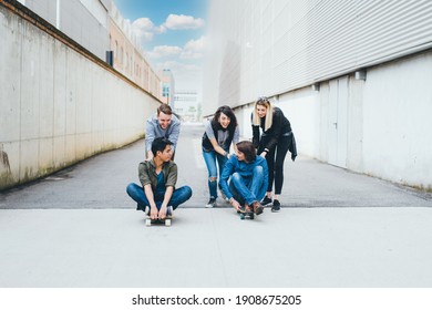 group of friends multiethnic having fun doing skateboard racing spending time in the weekend 