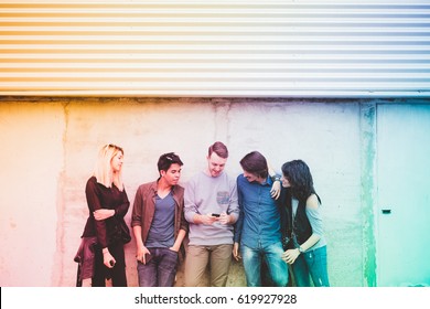 Group Of Friends Multiethnic Millennials Outdoor Using Smart Phone - Technology, Social Network, Togetherness Concept - Filtered Colorful