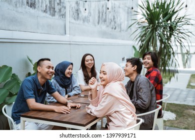Group of friends office meeting together in cafe - Shutterstock ID 1397939171