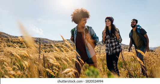 Group of friends on country walk. Young people hiking in countryside. - Shutterstock ID 1820524994