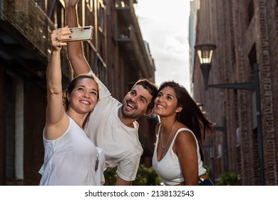 Group of friends on vacation. Group of friends taking a selfie in the city. Friends vacation. Friends sharing a moment - Powered by Shutterstock