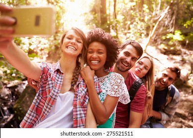 Group Of Friends On Walk Taking Selfie In Forest - Powered by Shutterstock