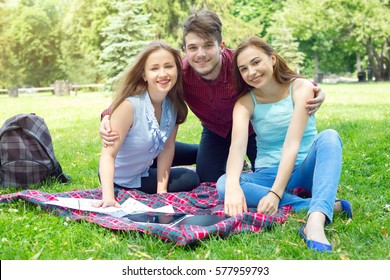 Group of friends - one man and two women. The joint rest and picnic. Life style.