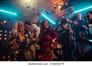 Group of friends partying in a club and moving to the music. - Shutterstock ID 1918350779