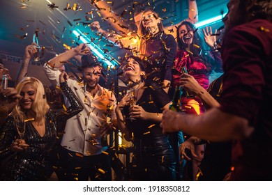 Group of friends partying in a club and moving to the music - Powered by Shutterstock