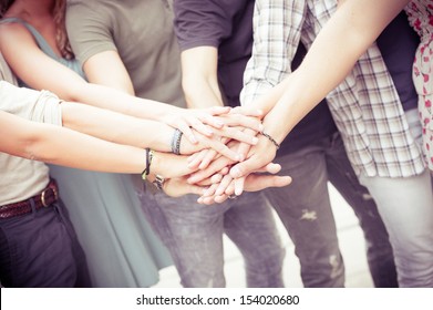 Group Of Friends Pile Up Hands As Unity Oath,Italy