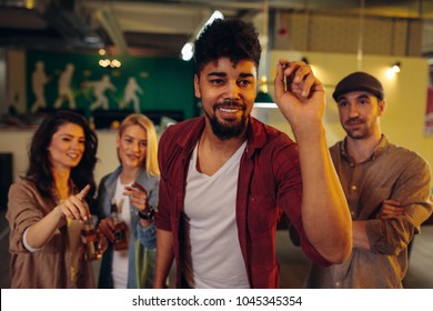 Group Of Friends Playing Darts