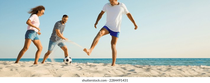 Group of friends playing football on sandy beach, space for text. Banner design - Powered by Shutterstock