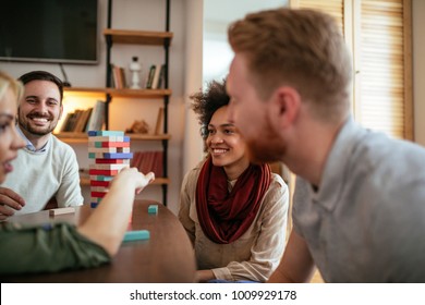 Group Of Friends Playing Game Of Jenga