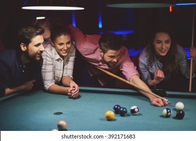 Group Of Friends Playing Pool Game