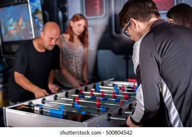 Group of friends playing soccer table foosball - Shutterstock ID 500804542