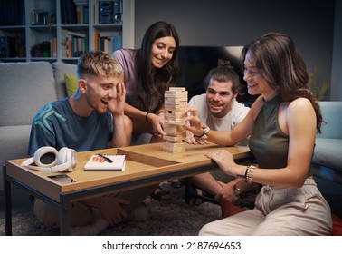 Group Of Friends Playing Table Games At Home, They Are Playing Together