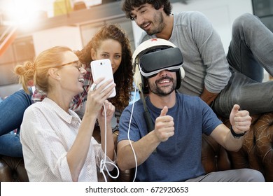 Group of friends playing together with virtual reality headset