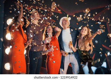 A group of friends posing and having fun with snowmen and champagne. New Year Celebration