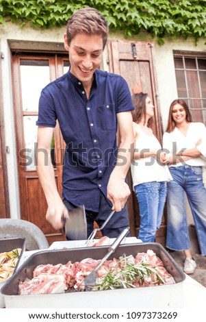 Similar – Gruppe von Freunden, die bei einem Sommergrill kochen.