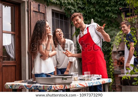 Similar – Gruppe von Freunden, die bei einem Sommergrill kochen.