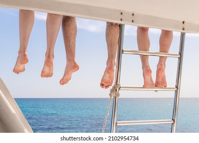 Group Of Friends Relaxing On The Boat Deck After Snorkeling In The Caribbean Sea In Cuba.