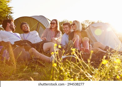 Group Of Friends Relaxing Outside Tents On Camping Holiday - Powered by Shutterstock