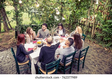 Group of friends at restaurant outdoors - People having dinner in a home garden