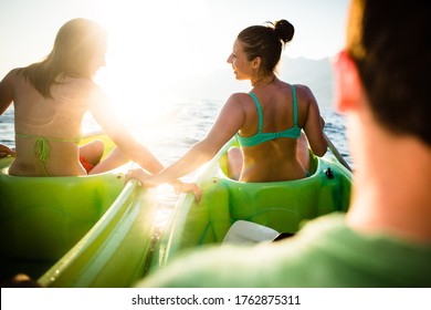 Group Of Friends Sea Kayaking On A Sunny Summer Day