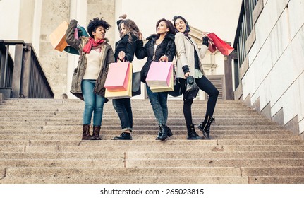 group of friends shopping together. concept about consumerism, shopping, mixed race, friendship and people