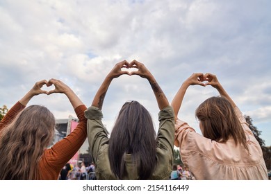 Group Of Friends Showing  Heard Shape At Music Festival 